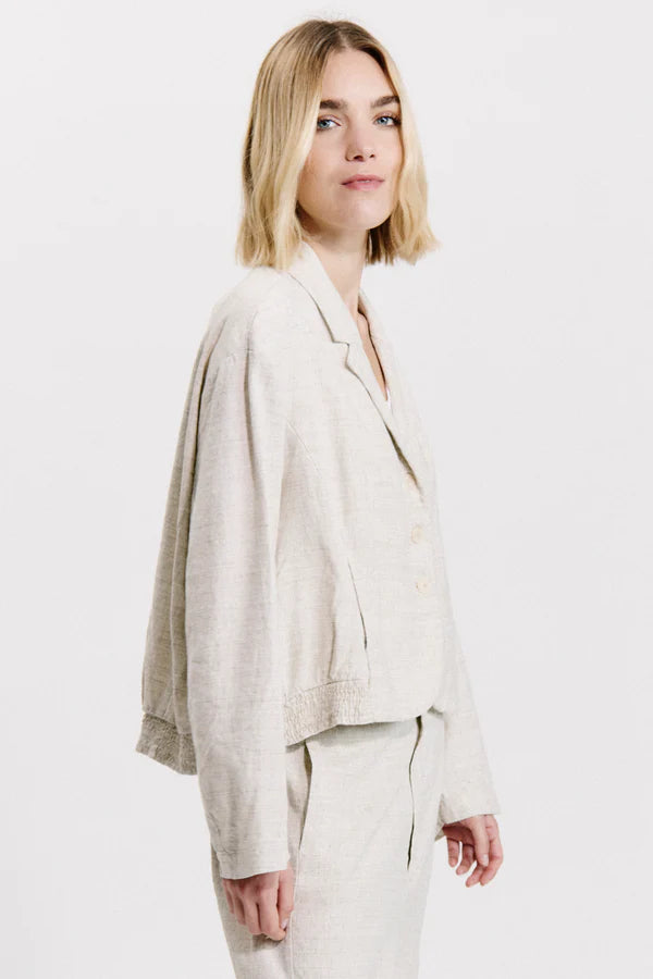 Flared over jacket with gathering motif on the bottom in linen and viscose stretch melange
