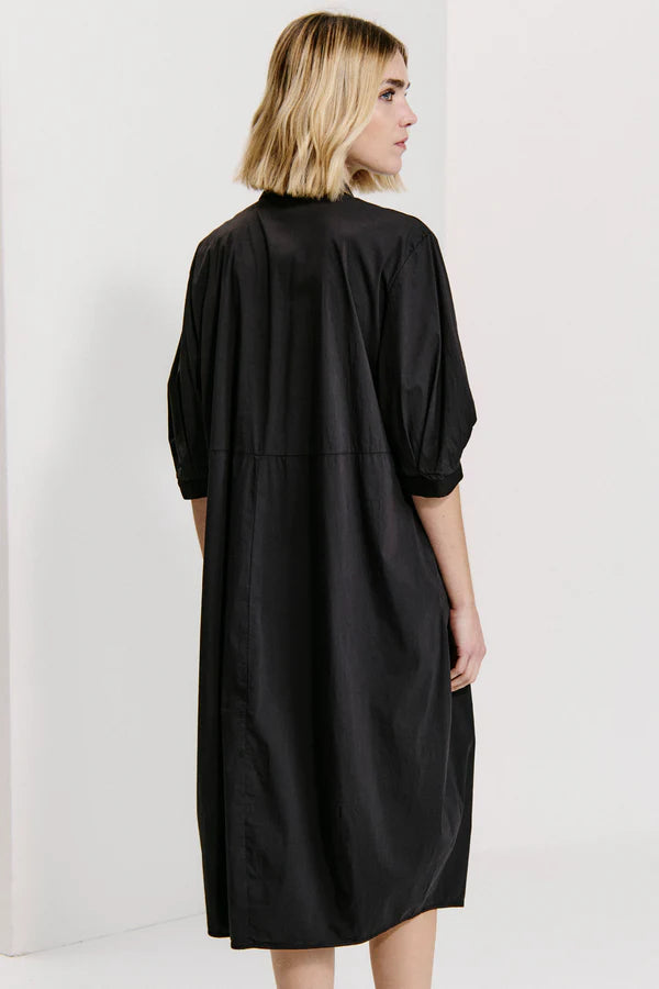 Bombe'-shaped calf-length dress with buttoned polo shirt opening and wide elbow-length sleeves in st